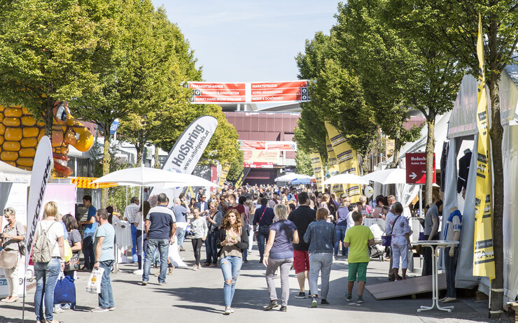 Messe Dornbirn Viele Messebesucherinnen und Besucher im Freigelände einer Messe unterwegs.