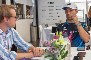 Der Formel-1-Fahrer Pierre Gasly unterhält sich mit einem Journalisten.