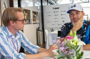 Der Formel-1-Fahrer Pierre Gasly unterhält sich mit einem Journalisten.