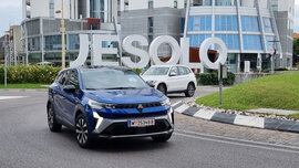 Ein blaues SUV fährt auf einem Kreisverkehr, im Hintergrund steht in großen Buchstaben "Jesolo"