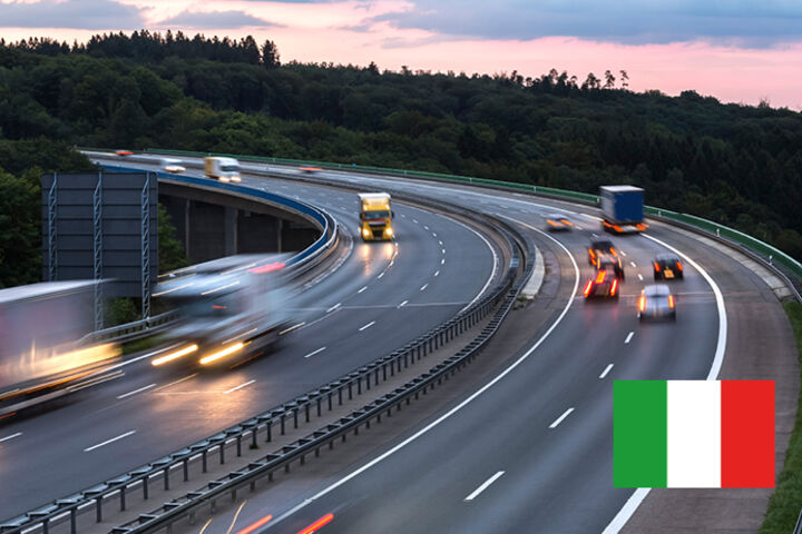 Eine Autobahn mit fahrenden Autos in der Dämmerung in Italien