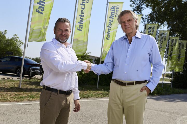Bild von einem Handschlag von Andreas Rouschal (links im Bild) mit Vorgänger Karl-Martin Studener (rechts im Bild) für gelben ÖAMTC-Fahrtechnik-Fahnen