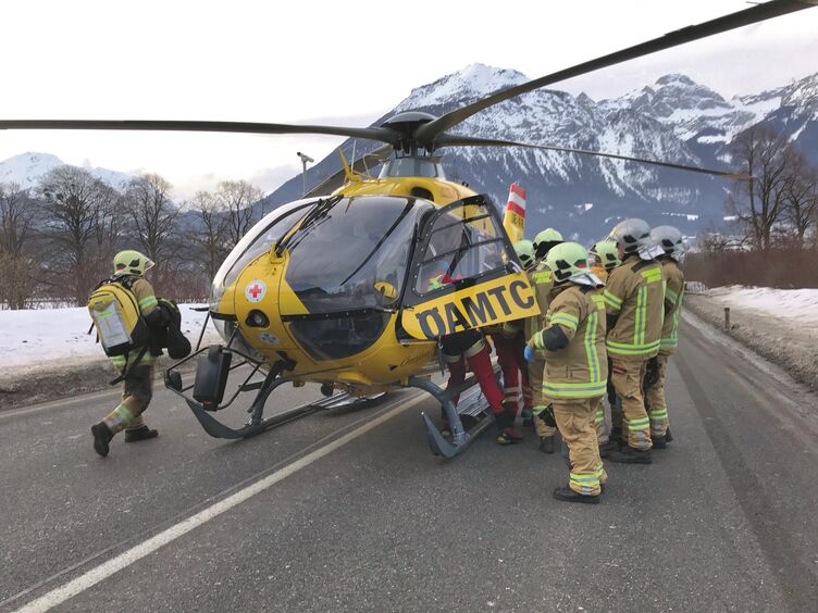 Elisabeth Wechselberger Ein ÖAMTC-Notarzthubschrauber, Feuerwehr und Polizei bei einem Unfall auf einer Straße. Am Straßenrand ist Schnee sichtbar.