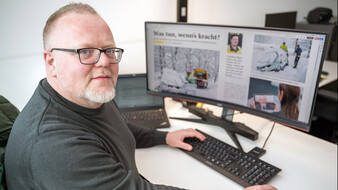 Eine Person sitzt vor dem Computer und arbeitet an einer Magazin-Geschichte.