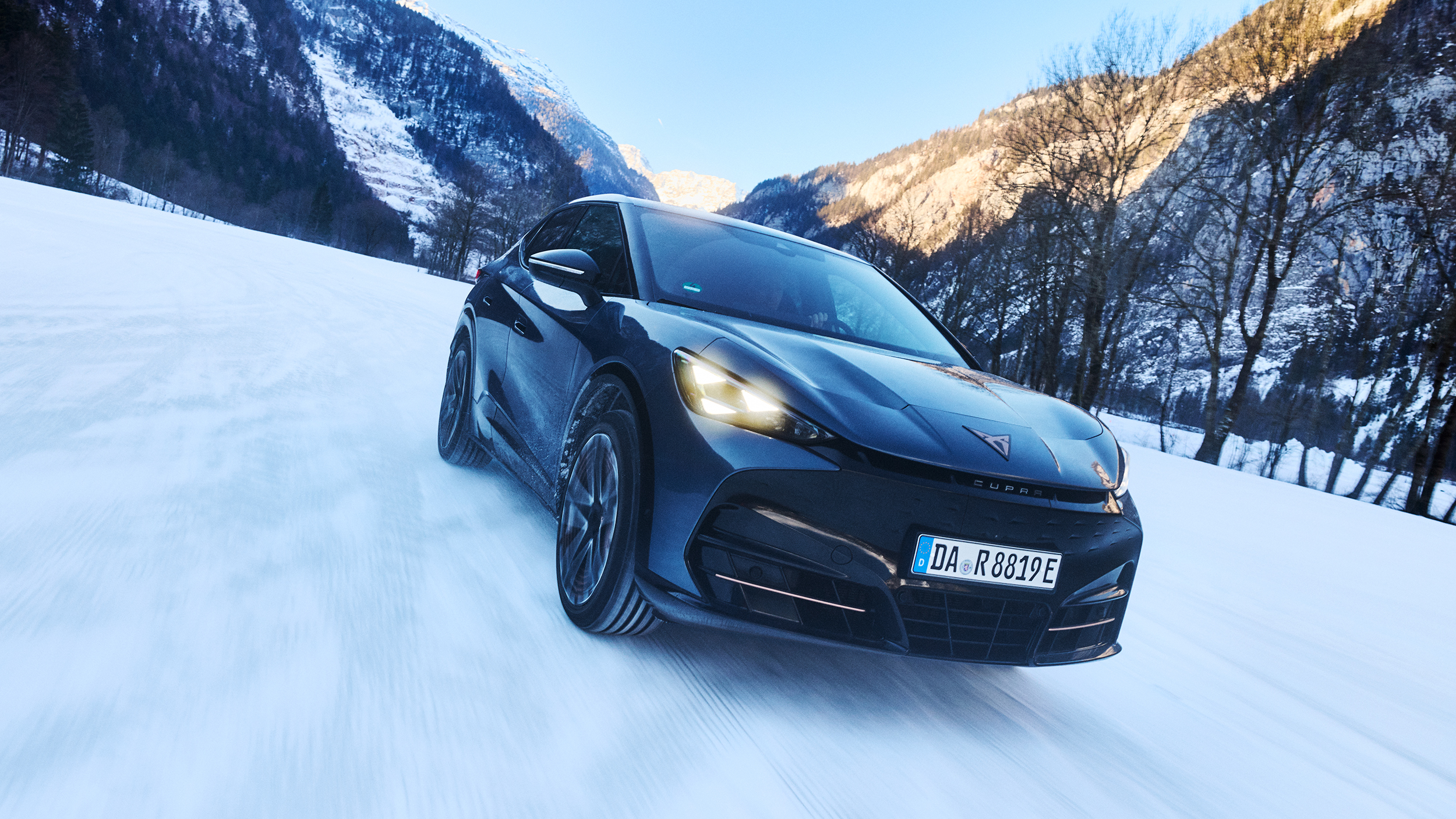 Ein Cupra Tavascan fährt auf einer verschneiten Fläche