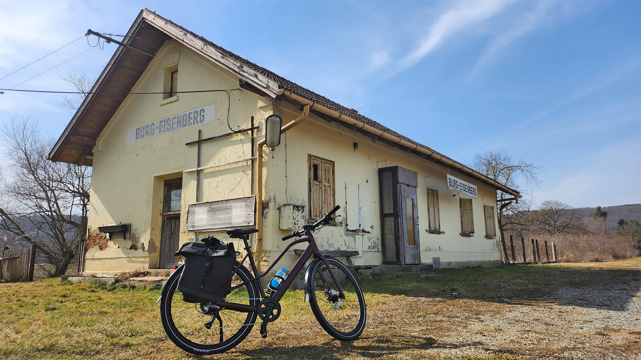 Der alte Bahnhof in Burg-Eisenberg. Das Gebäude ist schon verfallen. Ein Fahrrad steht davor.