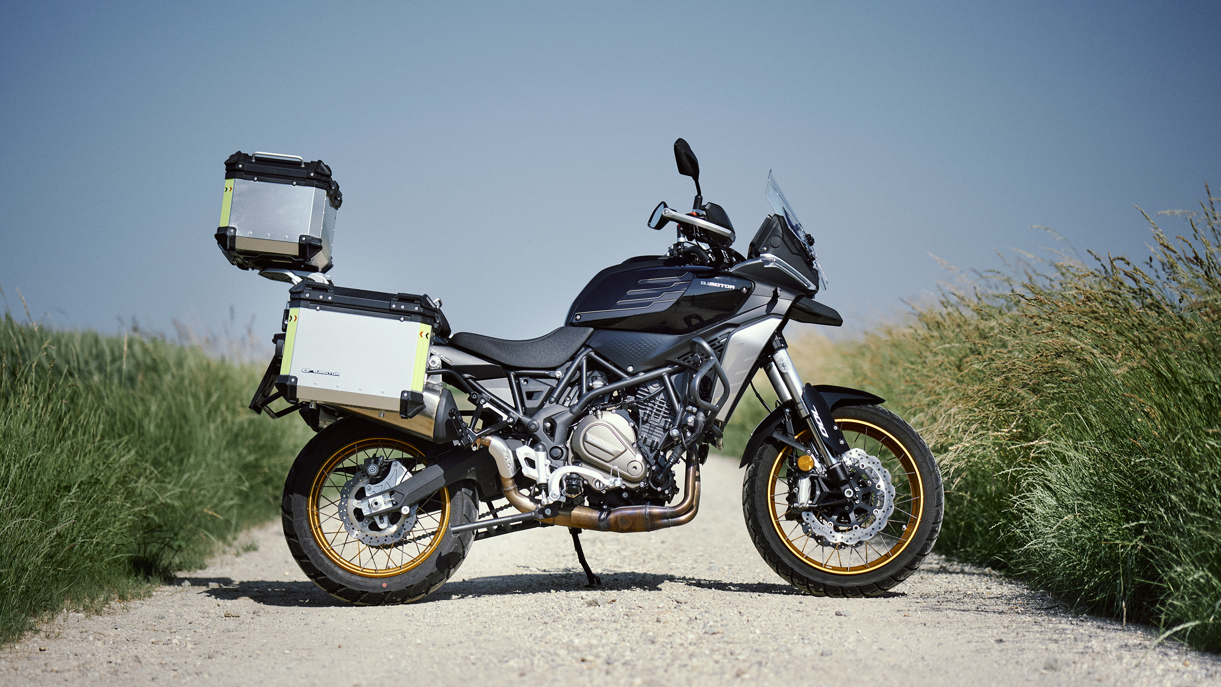 Die Mittelklasse Reiseenduro QJ SRT 700 SX mit drei am Heck montierten Alu-Koffern seitlich fotografiert.