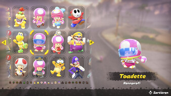 Screenshot aus Mario Kart World. Man sieht das Charaktermenü, Toadette ist ausgewählt in ihrem Outfit "Rennfahrprofi"
