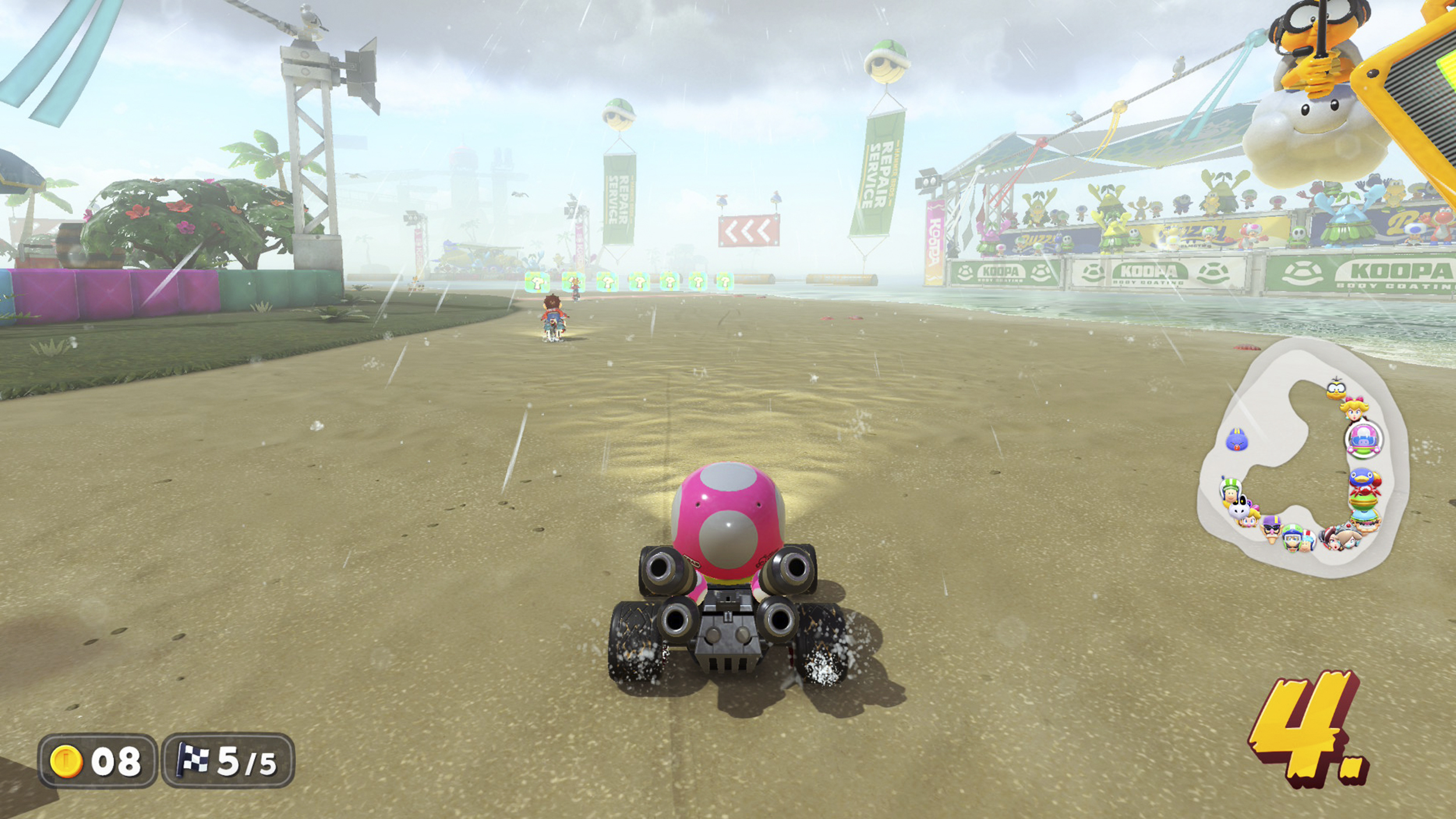 Screenshot aus Mario Kart World. Toadette ist im Rennen, es regnet.