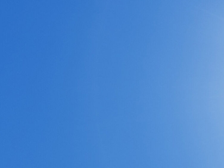 Auf dem Bild sieht man eine strahlende Sonne auf blauem Himmel.
