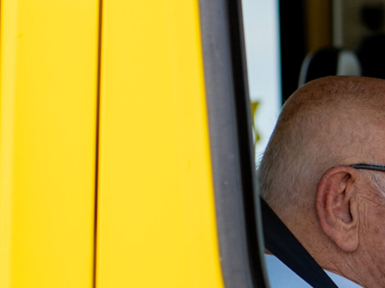 Auf dem Bild sieht man einen kleinen Ausschnitt, Durch ein offenes Autofenster wurden ein alter und ein junger Mann fotografiert.