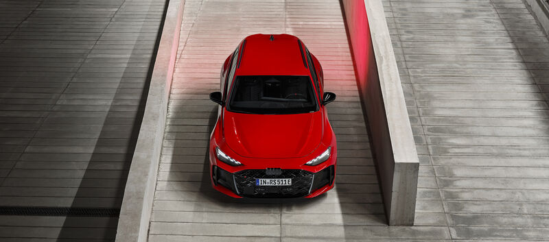 Eine roter Audi RS 5 Avant steht von oben fotografiert zwischen zwei Steinmauern.