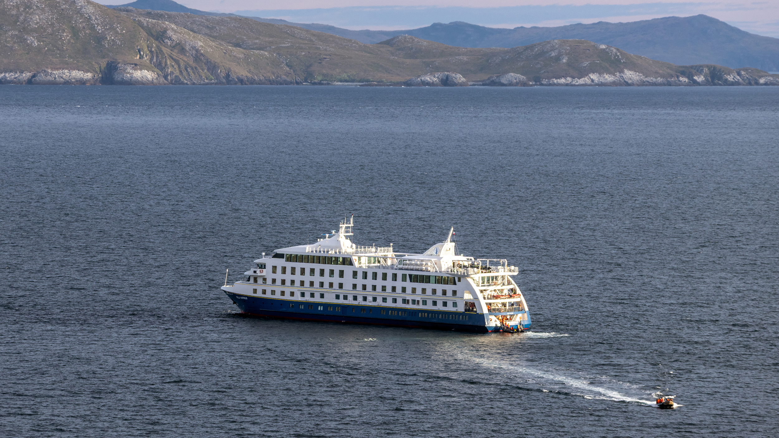 Stella Australis liegt vor Kap Hoorn vor Anker, ein Zodiac fährt soeben weg