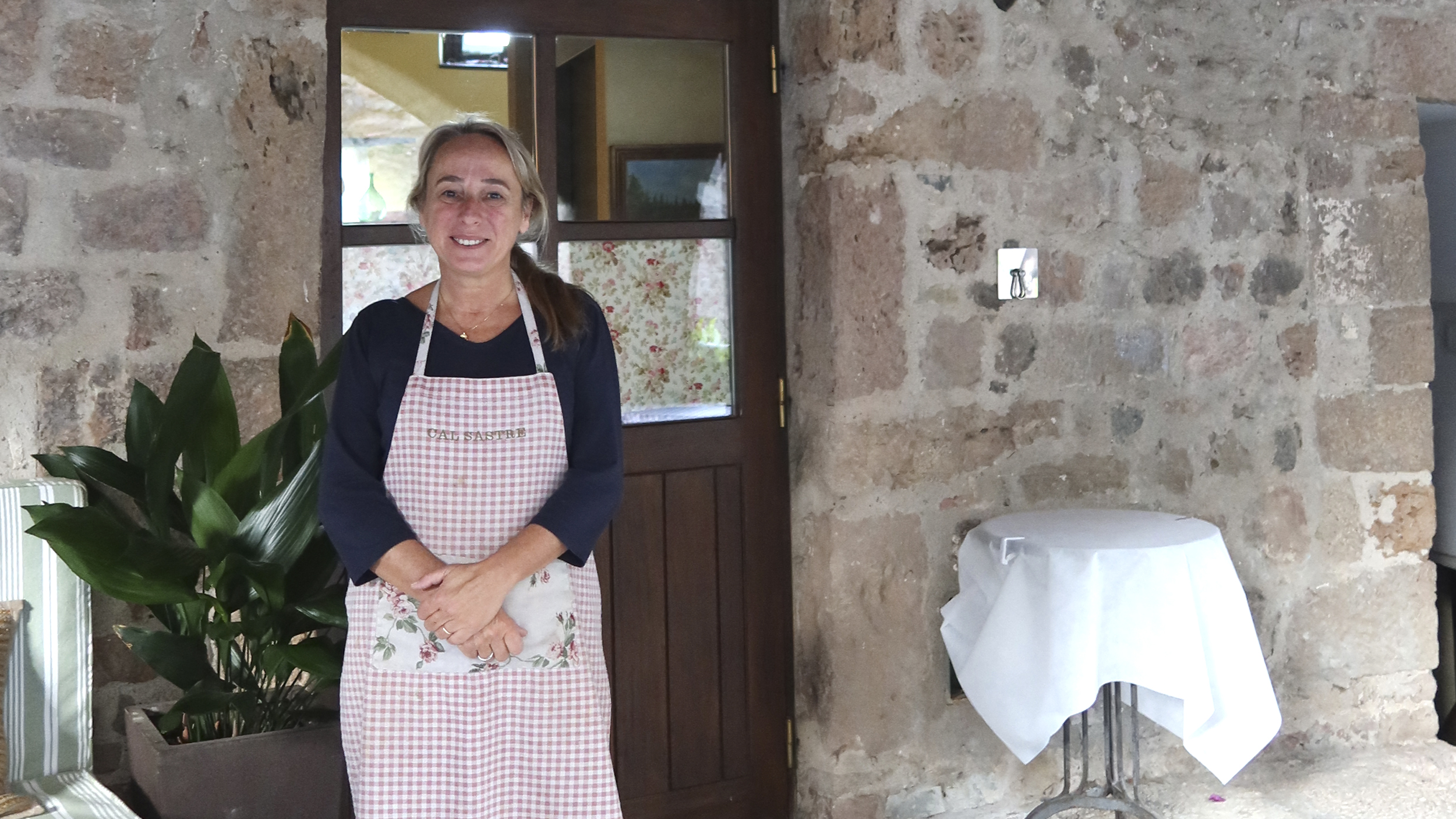 Hotelbesitzerin Eva Moliner steht vor dem Eingang des Restaurants in Santa Pau/Spanien.