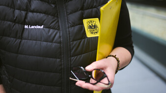 Nahaufnahme einer Hand mit Brille.