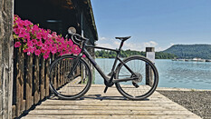 Gravelbike auf Bootsstegg mit türkis-blauem Wasser im Hintergrund
