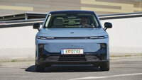 Frontansicht eines hellblauen Leapmotor B10 auf einem Parkplatz; eine Person sitzt am Steuer.