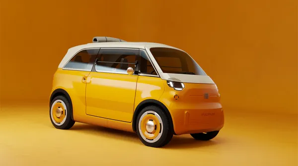 Orangefarbener Fiat Multiplina schräg von vorne mit weißem Dach, eingeschalteten Scheinwerfern, runden Außenspiegeln und einer grauen Rolle auf dem Dach.