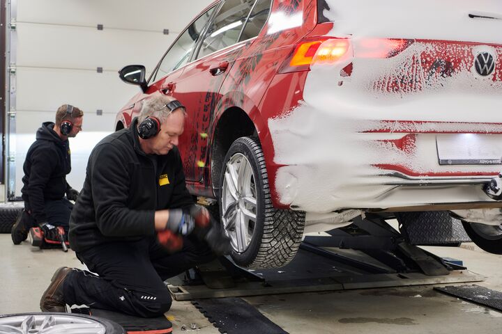 Techniker montieren Reifen an einem der Testfahrzeuge