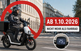 Ein Fahrer, der mit dem E-Moped mit Gepäck (25 km/h) in der Stadt unterwegs ist. Inschrift: Ab 1.10.2026 nicht mehr als Fahrrad.