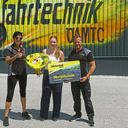 Die 150.000ste Teilnehmerin zusammen mit Zentrumsleiter Andreas Rouschal und Patricia Altmann vor einer Fahrtechnik-Graffitiwand