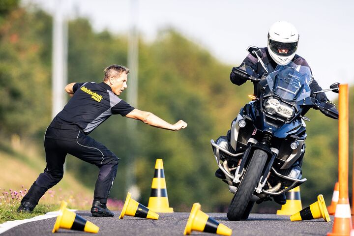 Ein Instrukor der ÖAMTC Fahrtechnik gibt einem Motorradfahrer energisch Anweisungen fürs korrekte Fahren