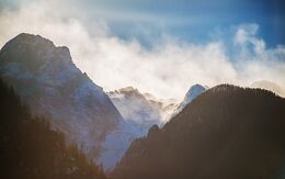 Das Foto zeigt die Berggipfel der Julischen Alpen in Slowenien vor blauem Himmel.