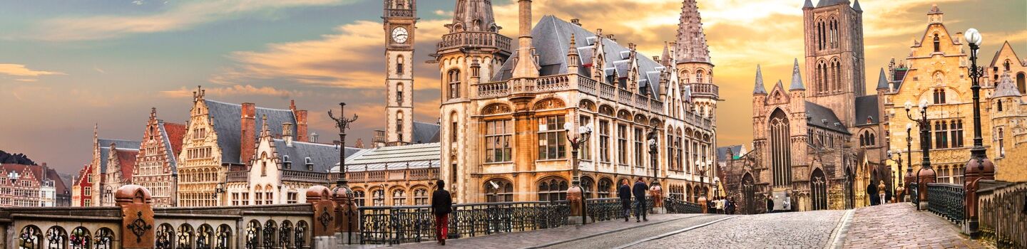 Panoramablick auf Gent (Belgien) mit historischen Gebäuden, Kanälen und belebten Plätzen bei Abendlicht