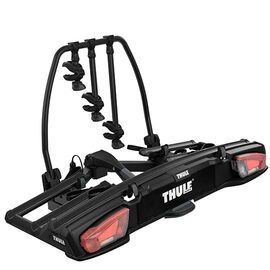 Schwarzer Fahrradträger mit weißer Aufschrift Thule und roten Rücklichter.