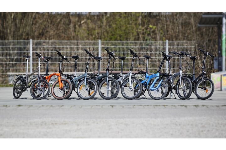 Das Bild zeigt acht vom ÖAMTC und seinen Partnerorganisationen getestete Falt- und Klappräder. Alle acht Modelle stehen nebeneinander.