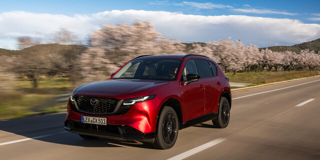 Ein roter Mazda CX-5 fährt auf einer Landstraße