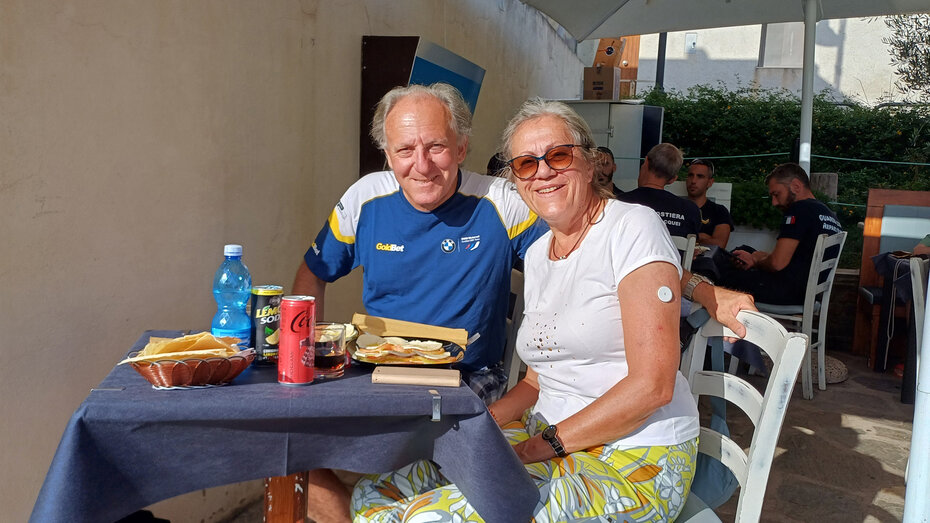 Ein älteres Ehepaar beim Frühstück auf einer Hotelterrasse.