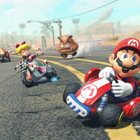 Screenshot aus Mario Kart World. Mario fährt in einem roten Auto in die Kurve.