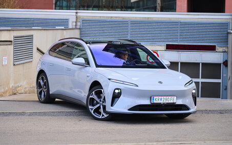 Ein hellblauer Nio ET5 Touring steht vor der Ausfahrt einer Tiefgarage.