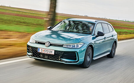 Blauer VW Passat auf Landstraße. Man sieht die Front der Autos. 